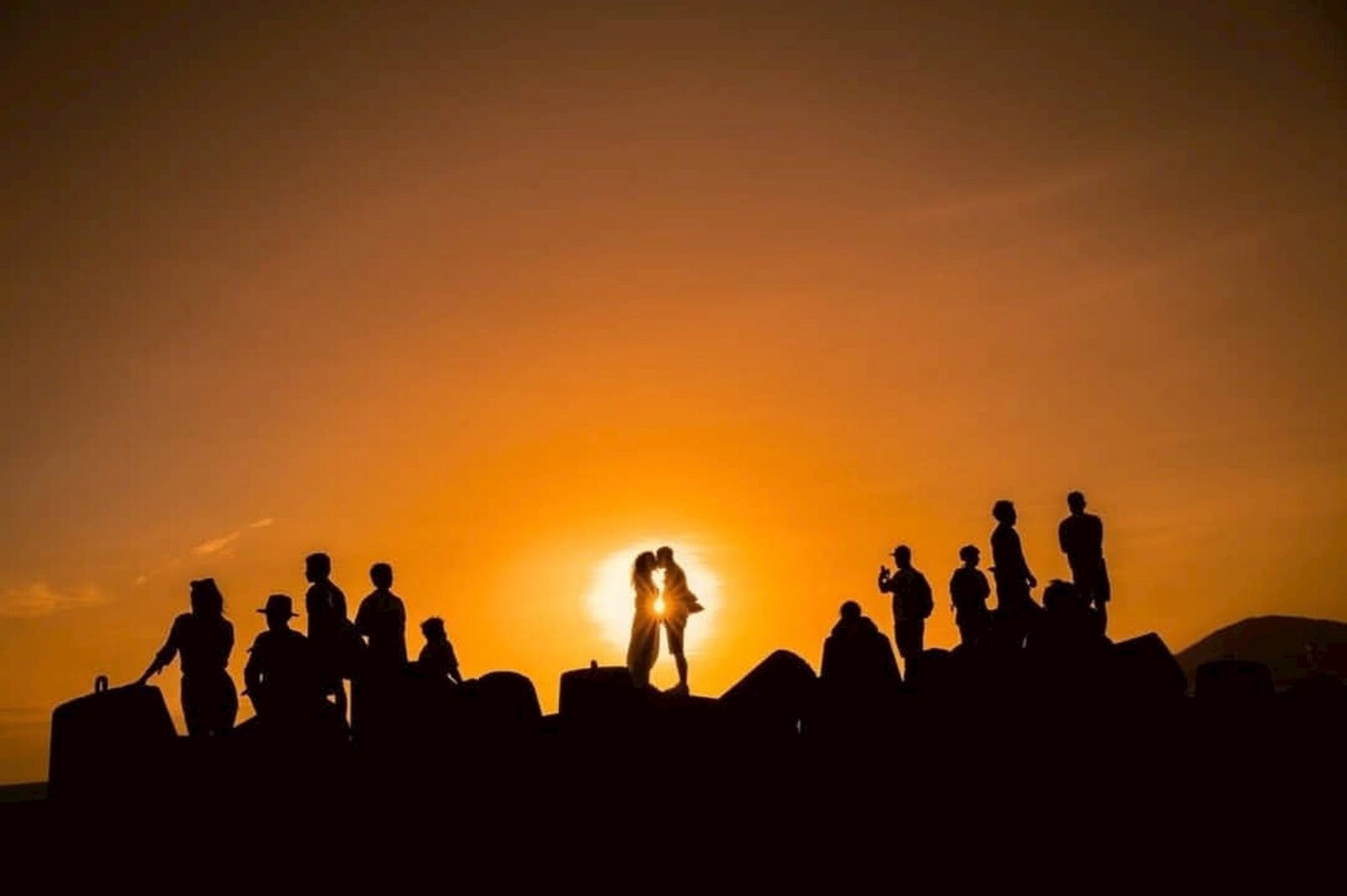 A group of people standing on top of a hill